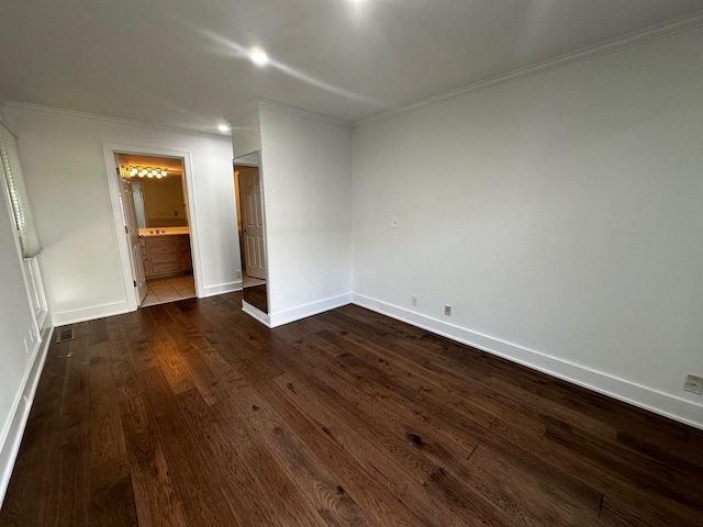 unfurnished bedroom featuring dark wood finished floors, baseboards, and ornamental molding