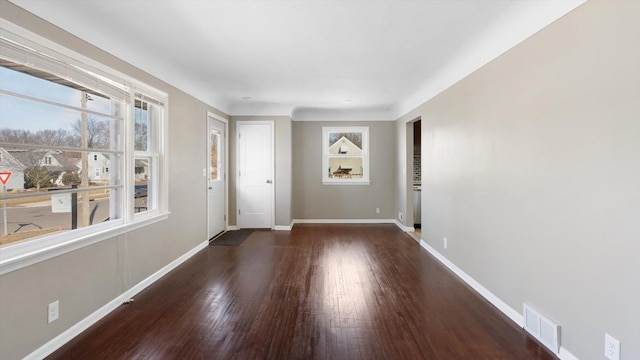 interior space with visible vents, baseboards, and wood finished floors