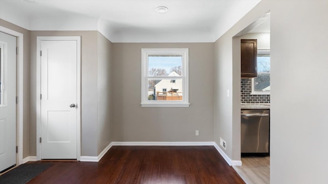 foyer with visible vents, baseboards, and wood finished floors