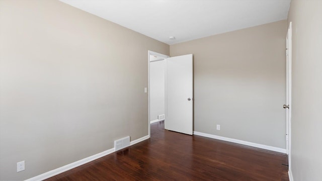 unfurnished bedroom with wood finished floors, visible vents, and baseboards