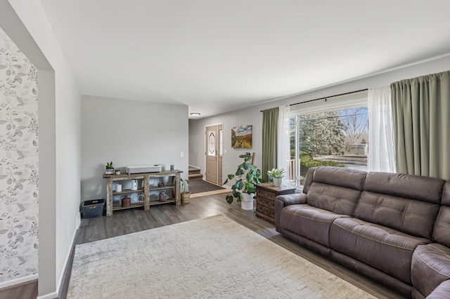 living area featuring stairs, wood finished floors, and baseboards