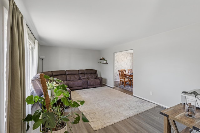 living room with baseboards and wood finished floors