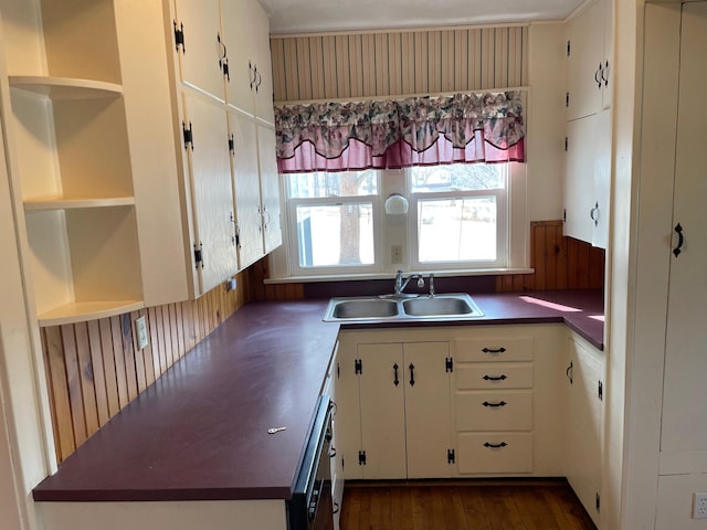 kitchen with open shelves, white cabinets, dark wood-style floors, and a sink