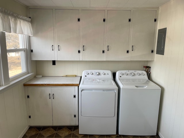 washroom featuring washer and dryer, electric panel, and cabinet space