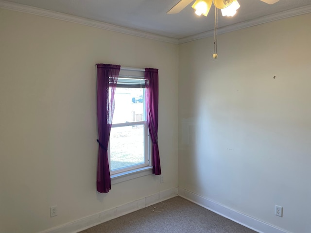 carpeted spare room with crown molding, a ceiling fan, and a wealth of natural light