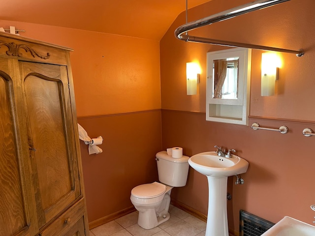 bathroom featuring tile patterned floors, toilet, and a sink