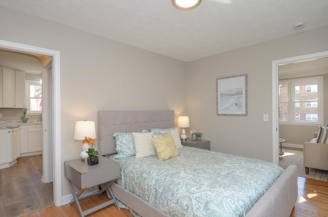 bedroom with baseboards and light wood-style flooring