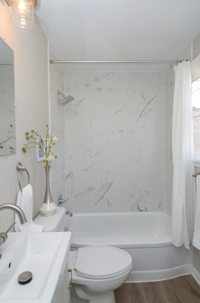 full bath with vanity, toilet, shower / tub combo with curtain, and wood finished floors