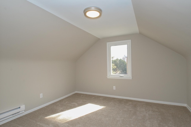 additional living space with carpet flooring, lofted ceiling, a baseboard heating unit, and baseboards