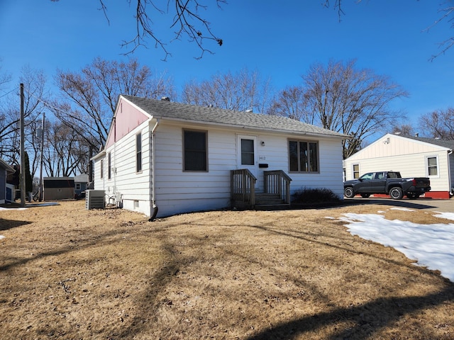 single story home featuring central AC and roof with shingles