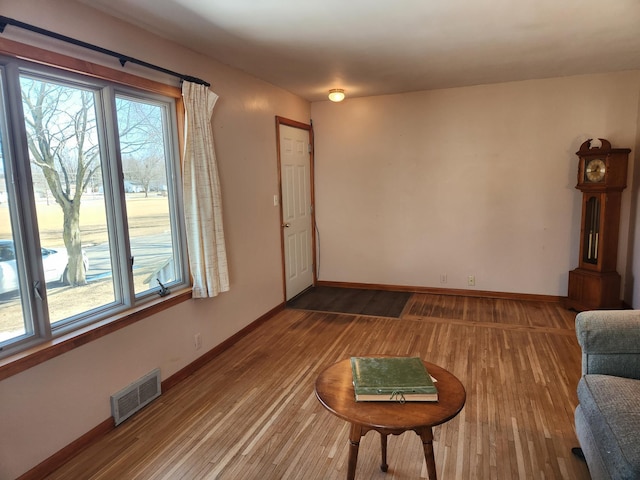 living room with visible vents, plenty of natural light, and wood finished floors