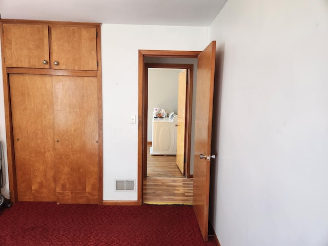 unfurnished bedroom featuring a closet, visible vents, and carpet floors