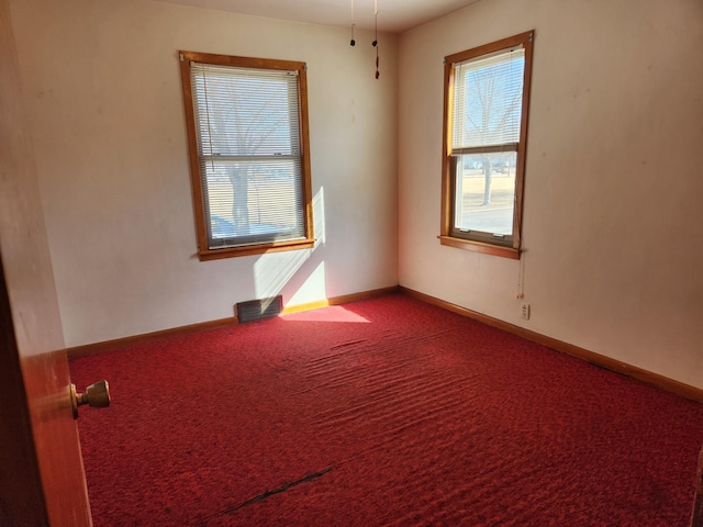 empty room with carpet flooring and baseboards