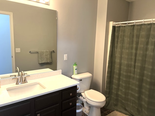 bathroom with vanity, a shower with shower curtain, and toilet