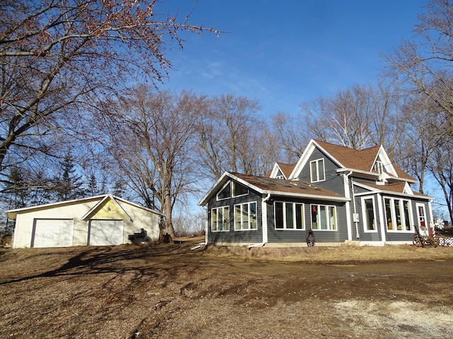 exterior space featuring an outbuilding and dirt driveway