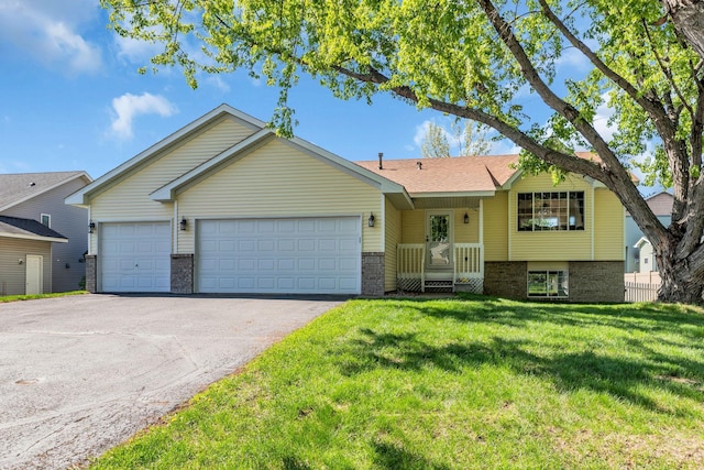 view of front of home with an attached garage, driveway, brick siding, and a front lawn