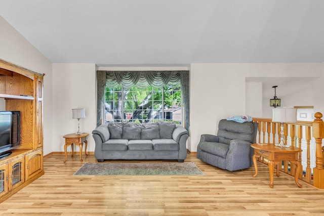 living area featuring light wood-style floors and baseboards