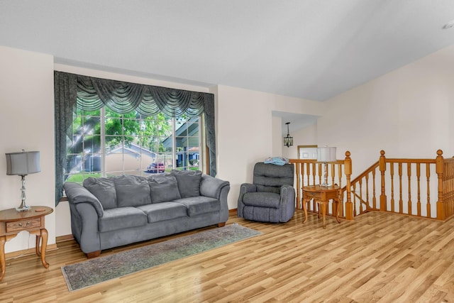 living area with light wood-style flooring and baseboards