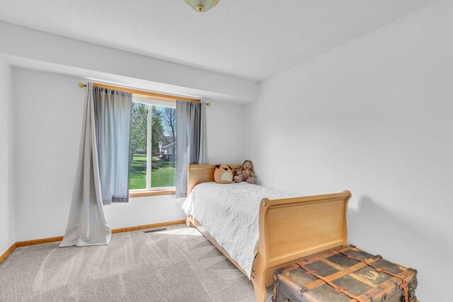 bedroom featuring baseboards and carpet