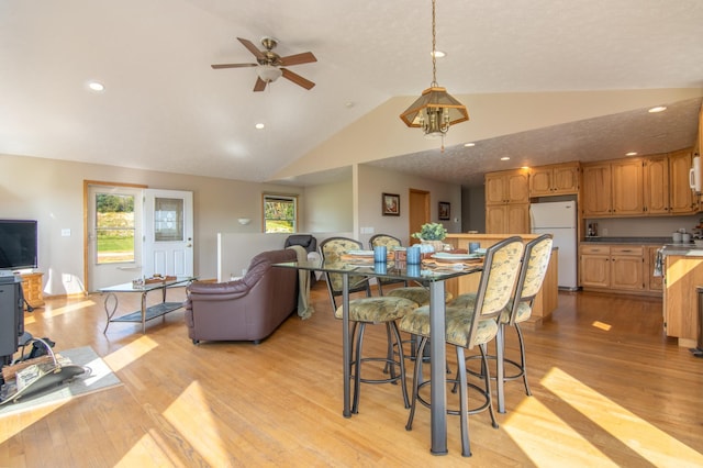 dining room with recessed lighting, lofted ceiling, ceiling fan, and light wood finished floors