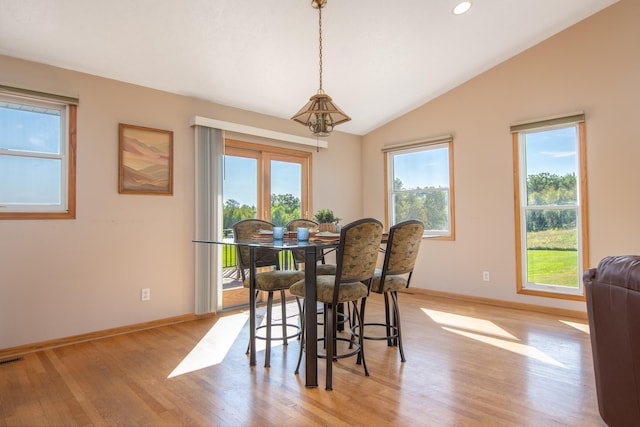 dining room with vaulted ceiling, recessed lighting, baseboards, and light wood-type flooring