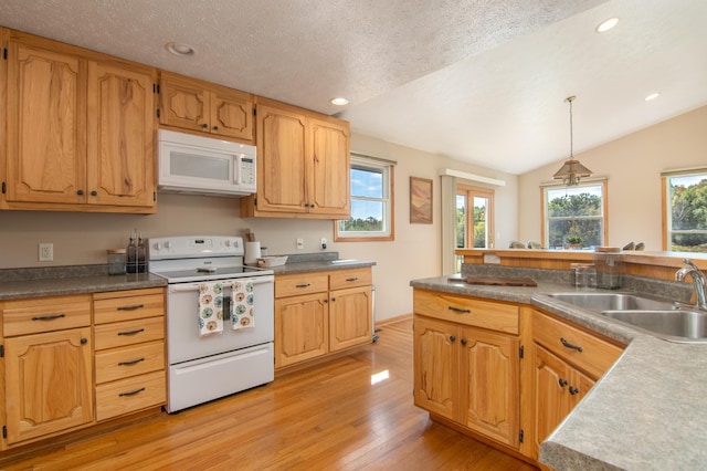 kitchen featuring lofted ceiling, light wood-style flooring, white appliances, a textured ceiling, and a sink