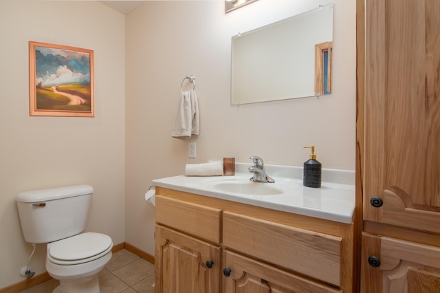 bathroom with tile patterned floors, toilet, vanity, and baseboards