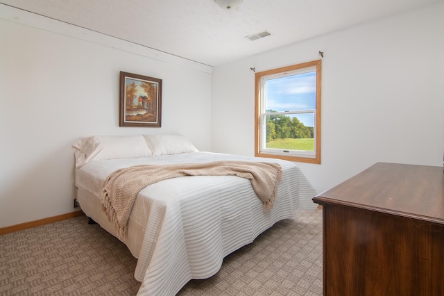 bedroom featuring light colored carpet, visible vents, and baseboards