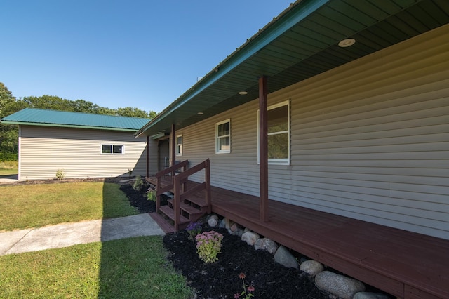 view of property exterior with a lawn and metal roof