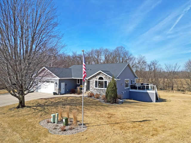 single story home with driveway, stone siding, a shingled roof, an attached garage, and a front yard