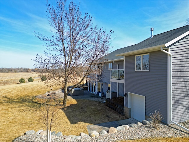 view of home's exterior featuring a lawn and a garage