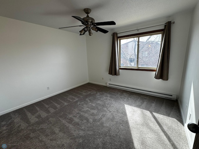 spare room with a textured ceiling, a baseboard heating unit, baseboards, and dark colored carpet