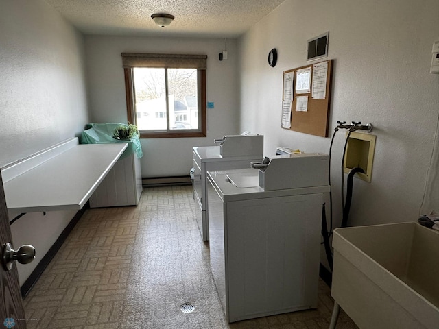 common laundry area with visible vents, brick floor, independent washer and dryer, a textured ceiling, and a sink