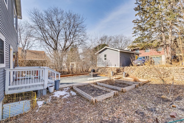 view of yard featuring a vegetable garden and a deck