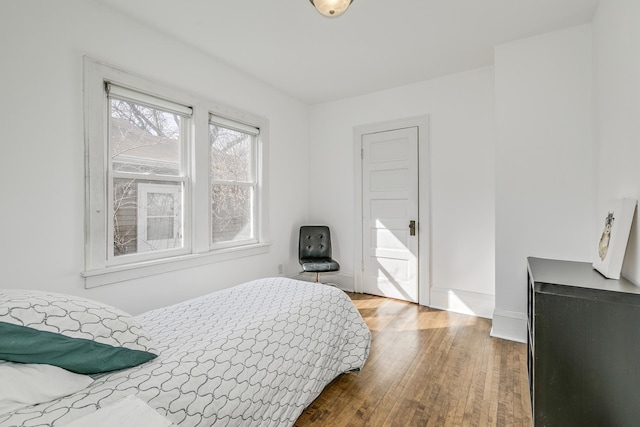 bedroom featuring baseboards and wood finished floors