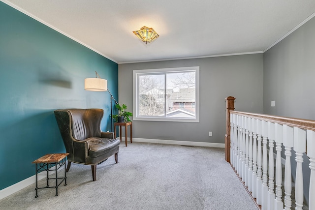 living area with carpet flooring, baseboards, and ornamental molding