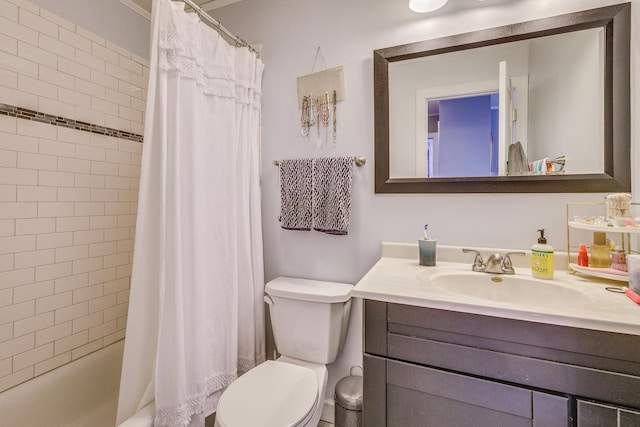 full bath featuring shower / tub combo, toilet, and vanity