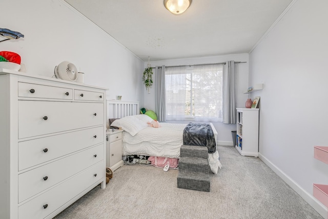 bedroom with light carpet, baseboards, and ornamental molding