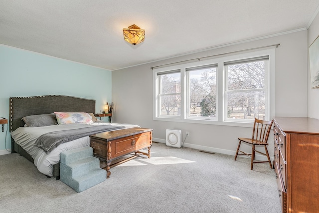 bedroom with visible vents, baseboards, carpet, and ornamental molding