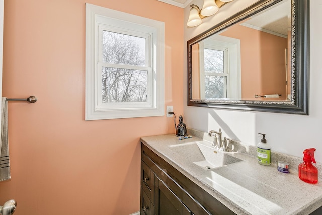 bathroom with vanity and ornamental molding