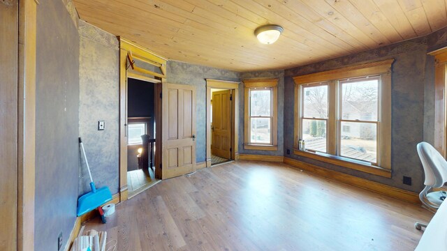 unfurnished bedroom featuring baseboards, wood finished floors, and wood ceiling