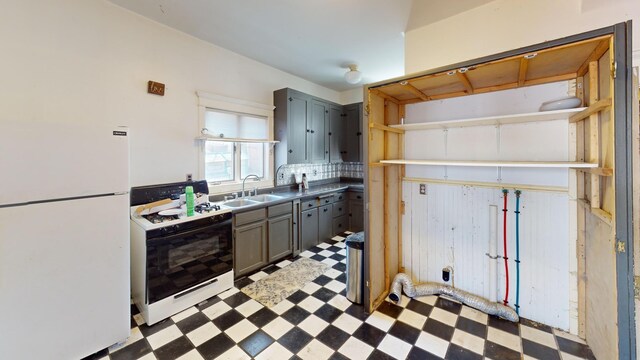 kitchen with light floors, a sink, and white appliances