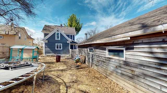 view of yard featuring an outdoor structure and fence