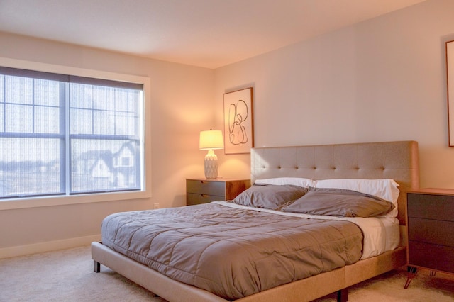 carpeted bedroom with baseboards