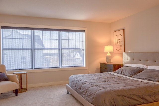 carpeted bedroom featuring baseboards