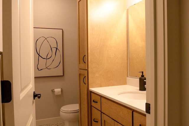 bathroom featuring toilet and vanity