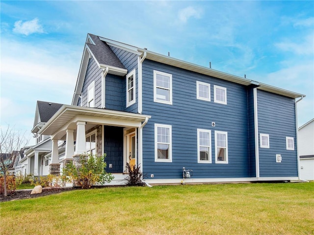 rear view of property with a lawn