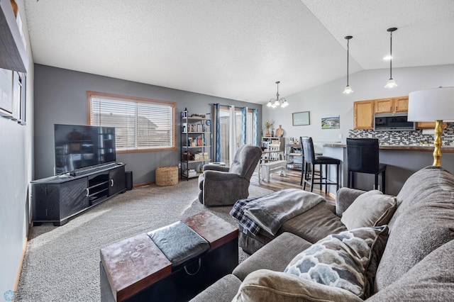 living room featuring lofted ceiling, a textured ceiling, carpet floors, and an inviting chandelier