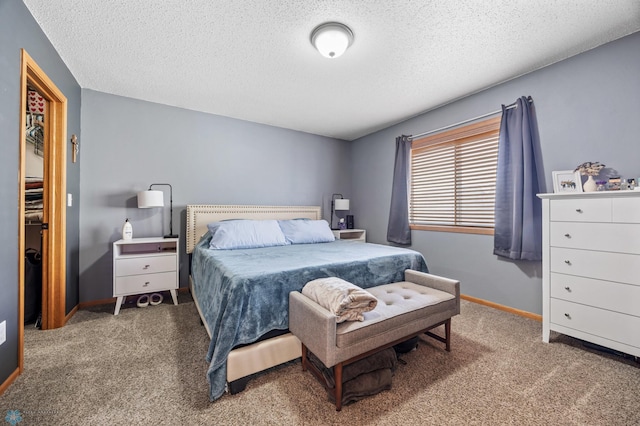 bedroom with a textured ceiling, baseboards, and carpet floors