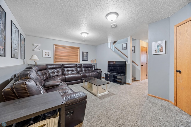 living room featuring stairway, carpet, baseboards, and a textured ceiling